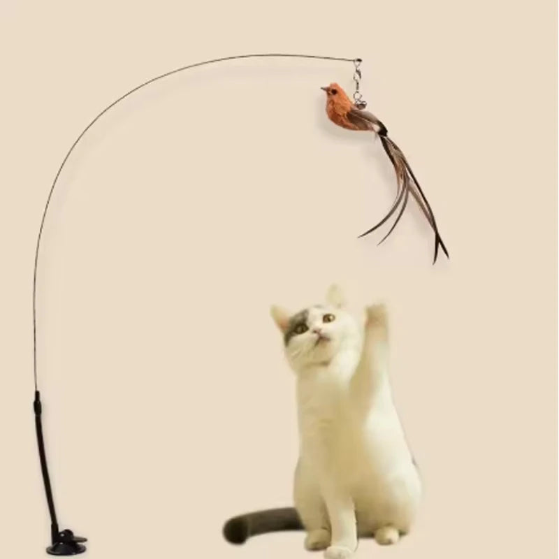 Gioco per gatti con piume, campanella e ventosa - bastoncino resistente al morso